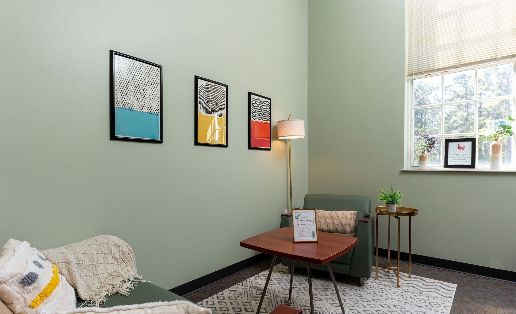 A light green room with many pictures in the GPAC building
