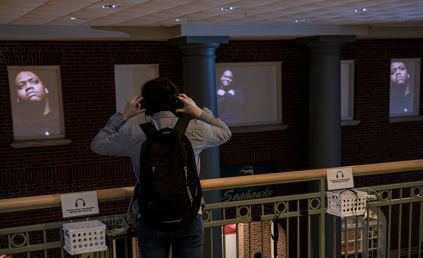 A student putting on headphones to listen to a history walk.