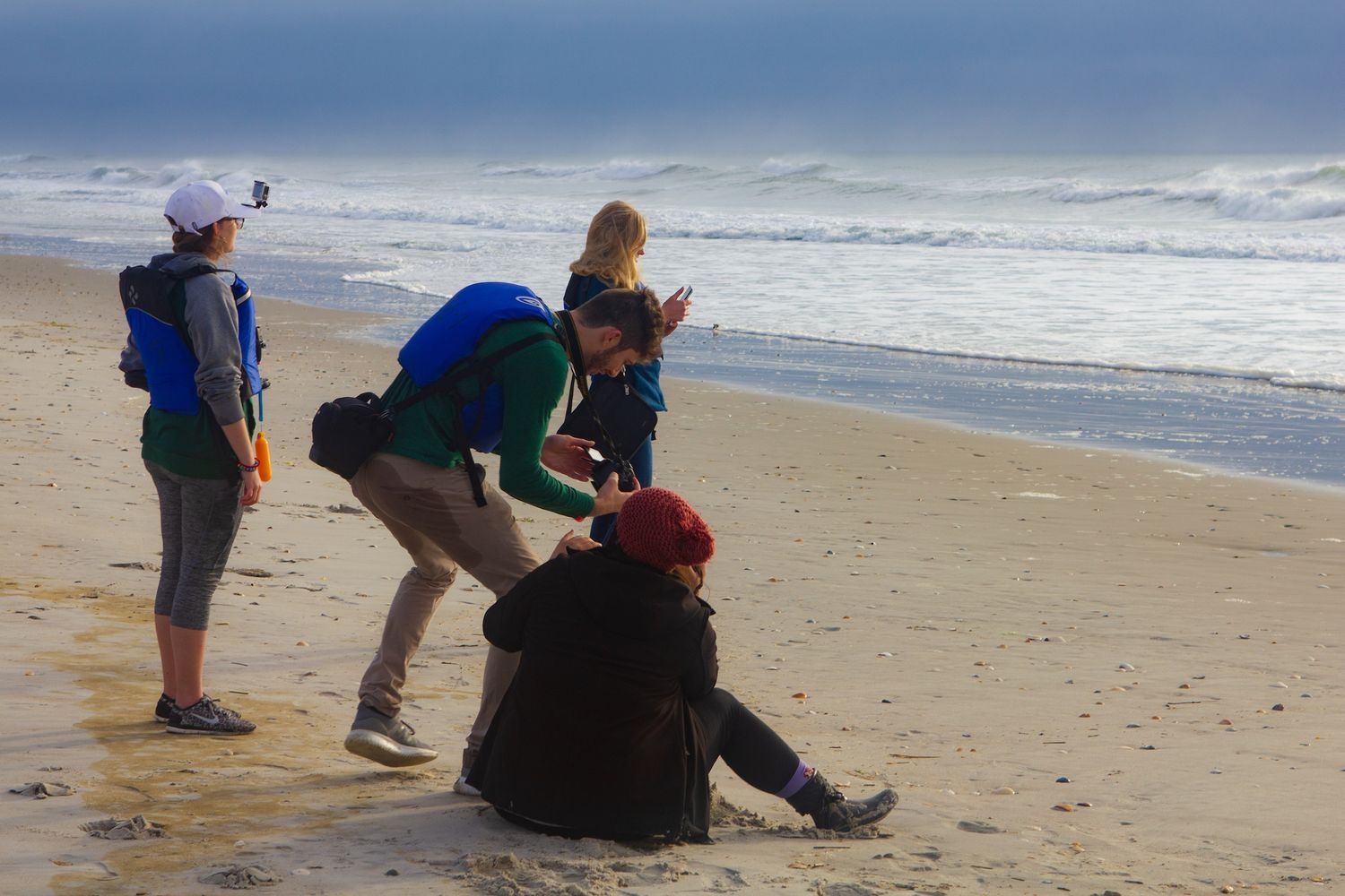 Students filming on the beach