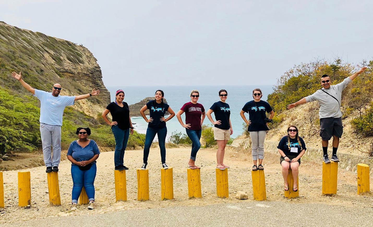 students pose on a beach during a study abroad trip