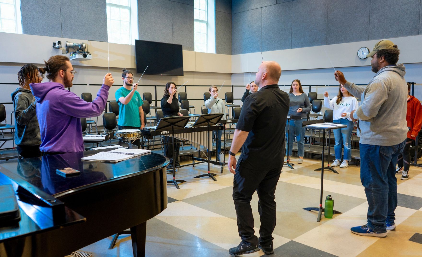 Students learn conducting etiquette in a music class