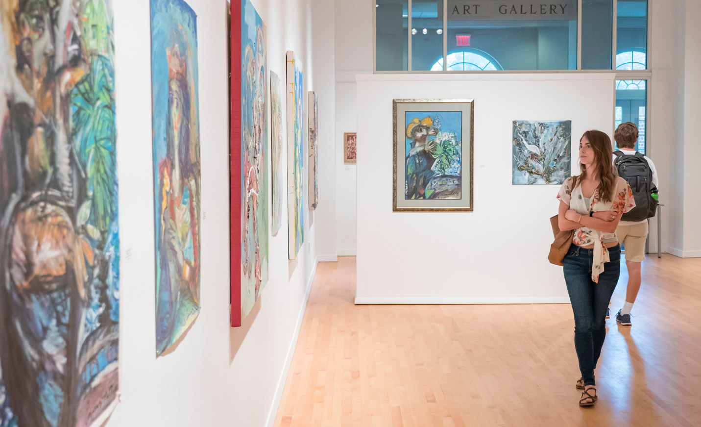 Student walking in art gallery