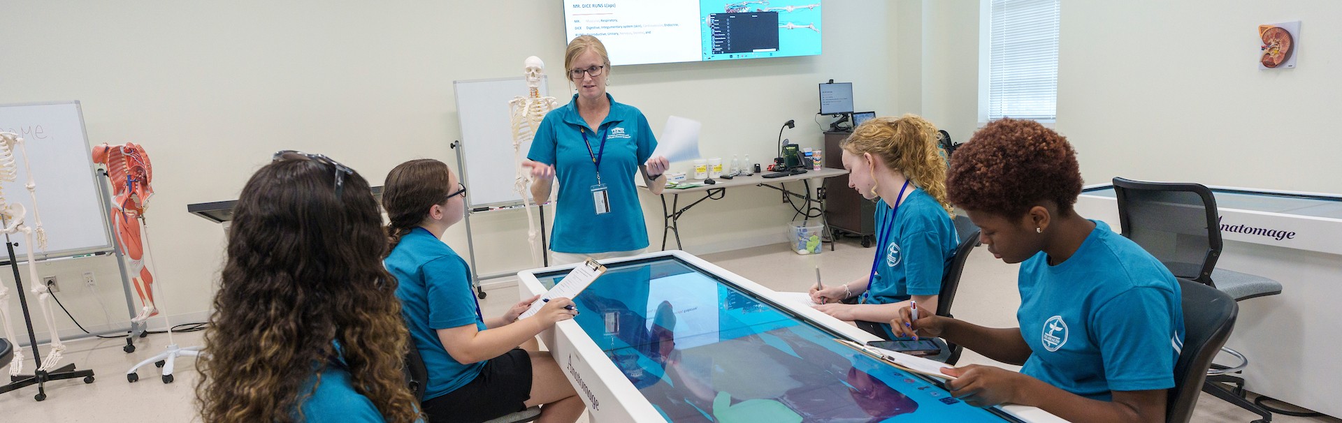 Students around digital anatomy table