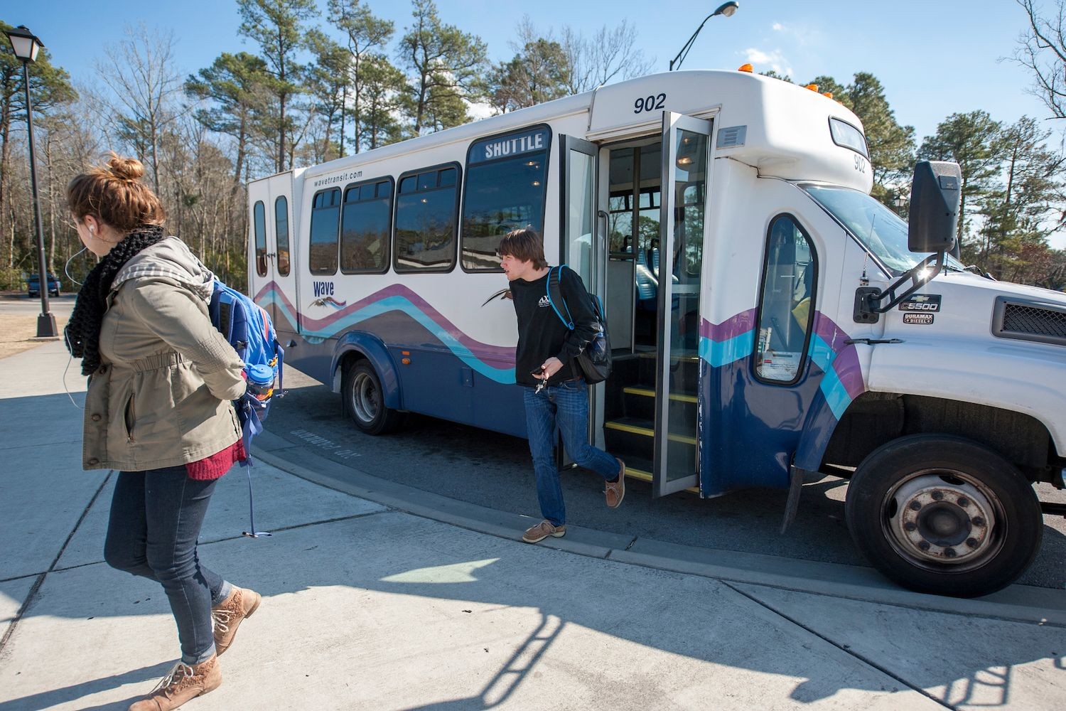 Students getting off shuttle bus