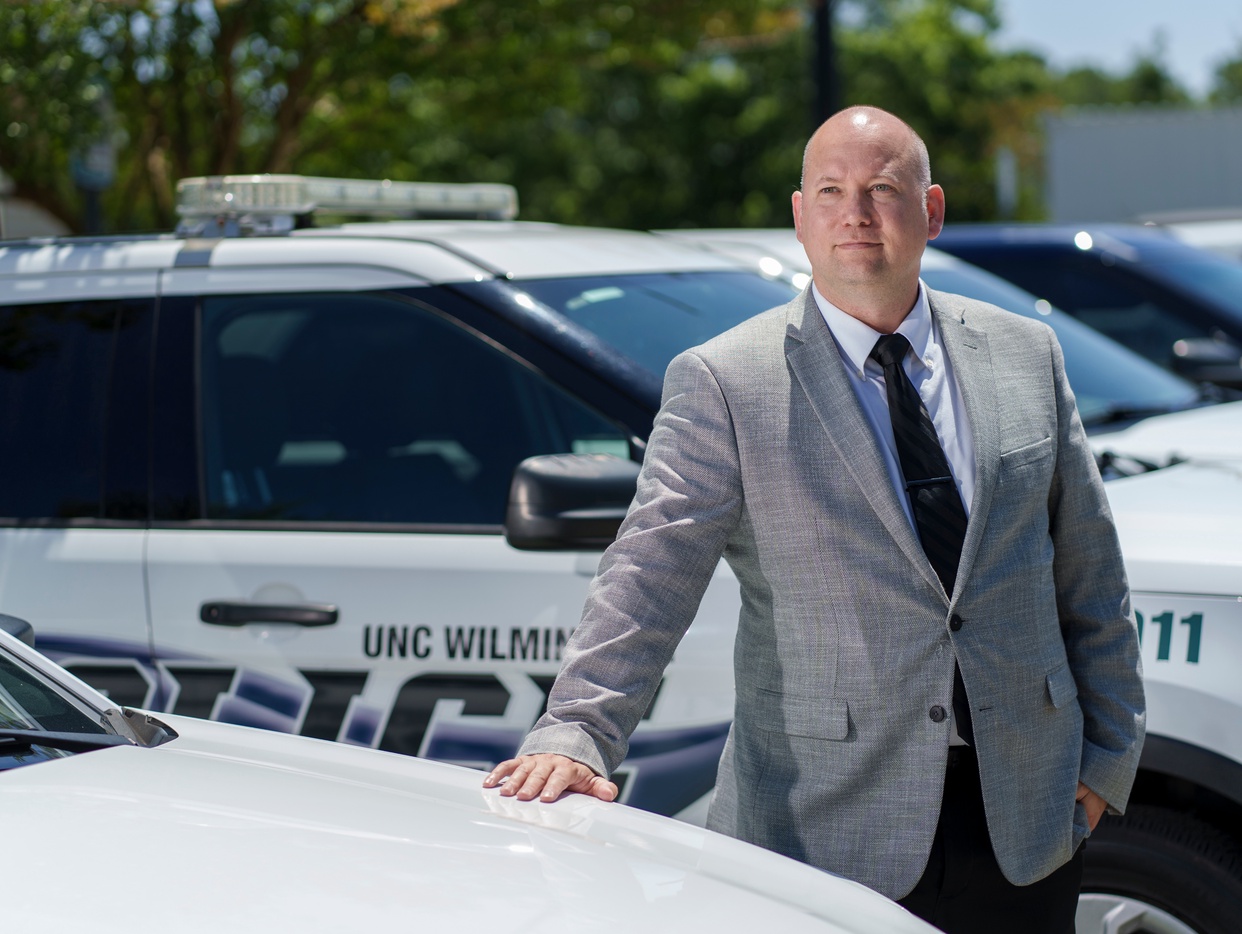 Police chief standing by police cars