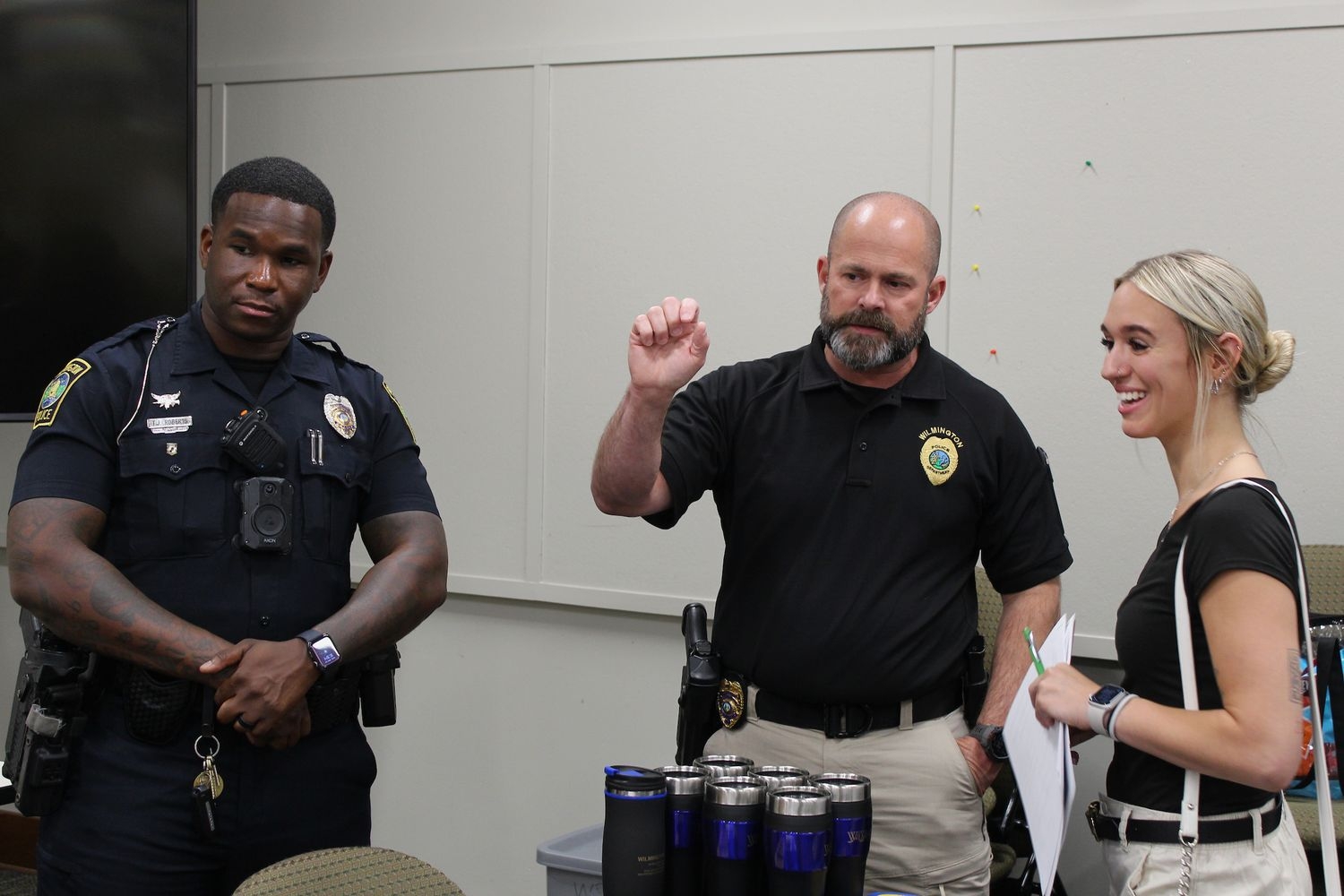A student speaks with law enforcement agents at a career fair