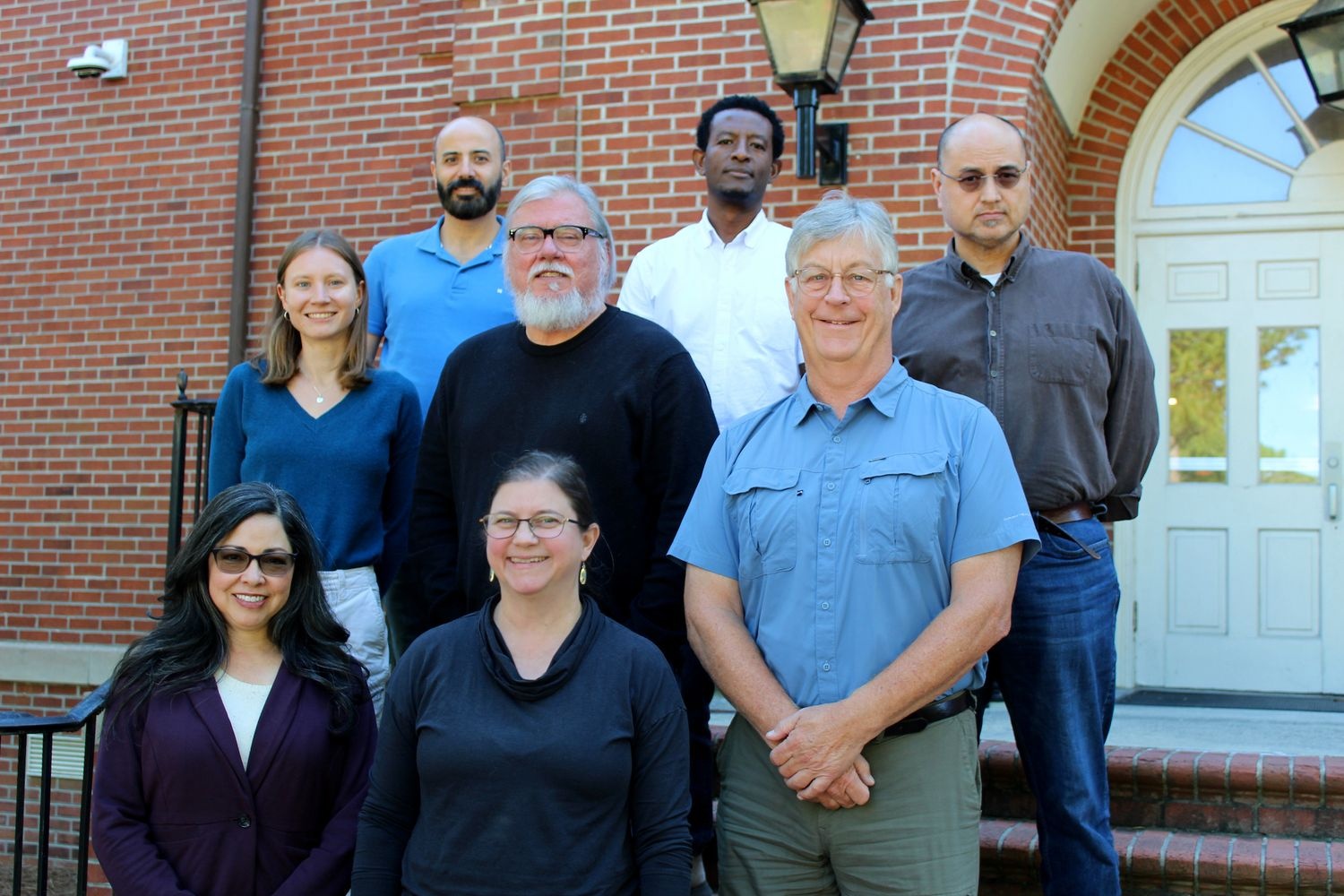 Anthropology faculty in front of a building