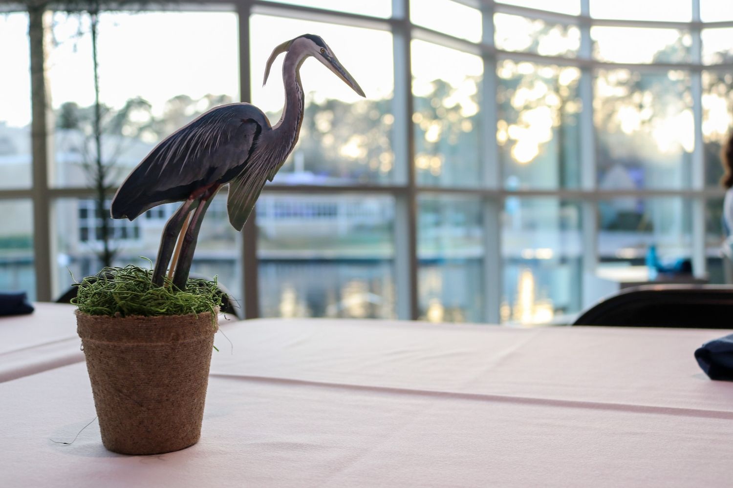 Heron statue in front of window