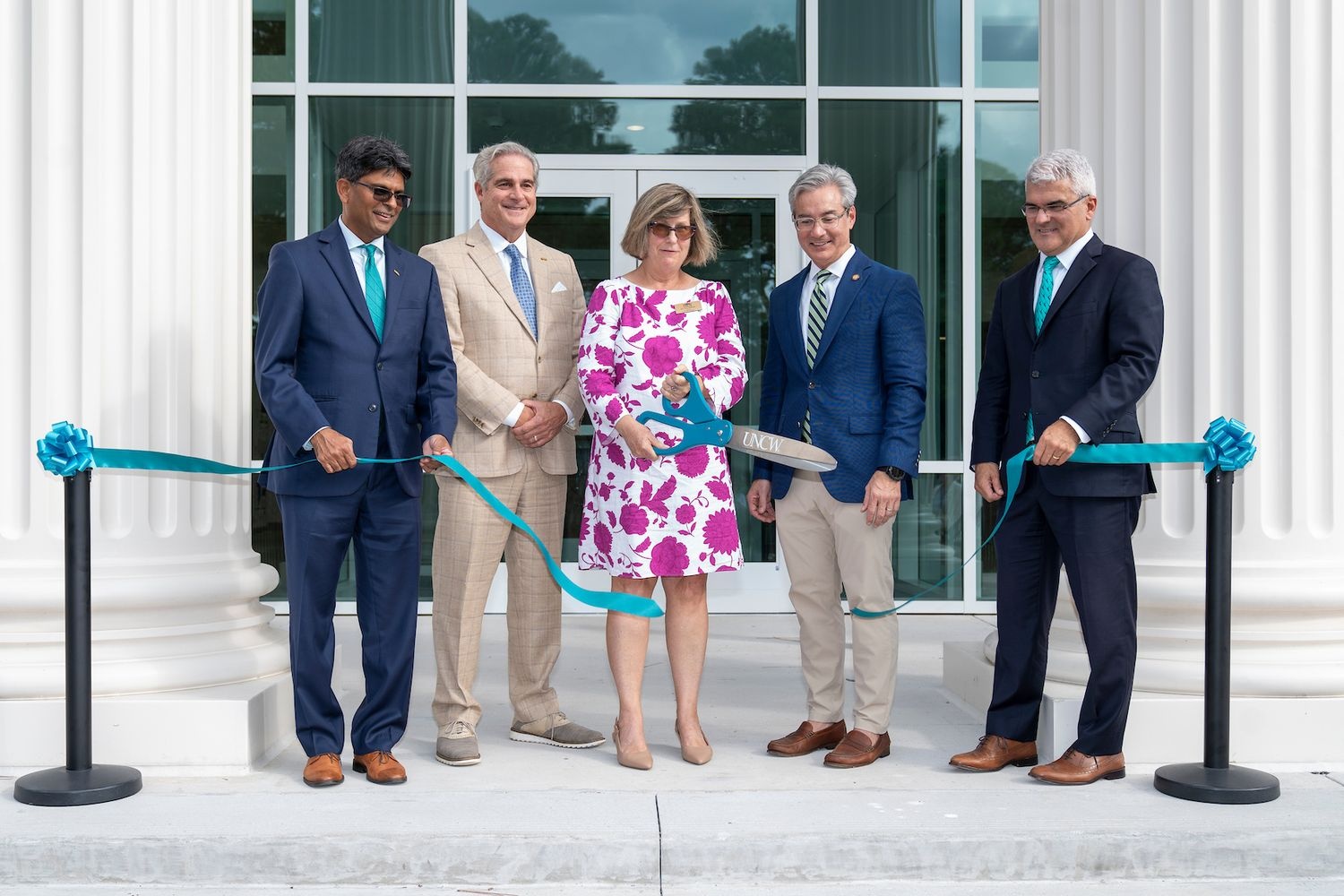 Ribbon cutting outside doors of Discovery Hall