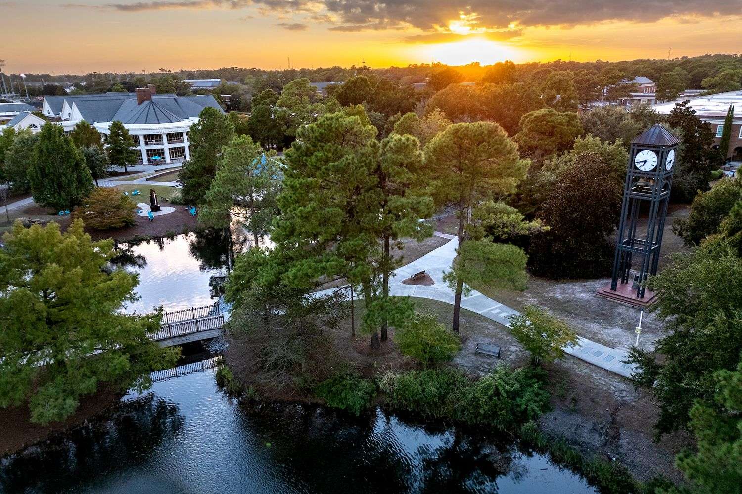 aerial shot of campus with clocktower at dusk