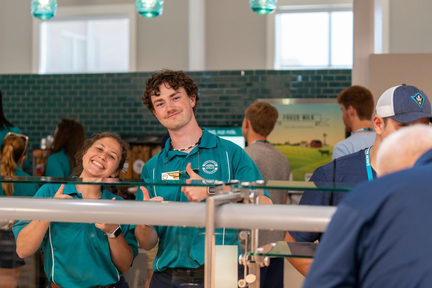 Students giving a thumbs up in the dining hall