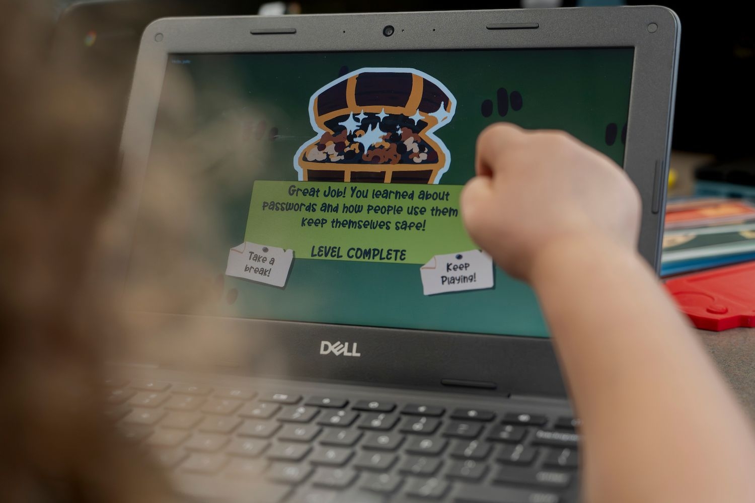 Child pointing at a screen with text talking about passwords