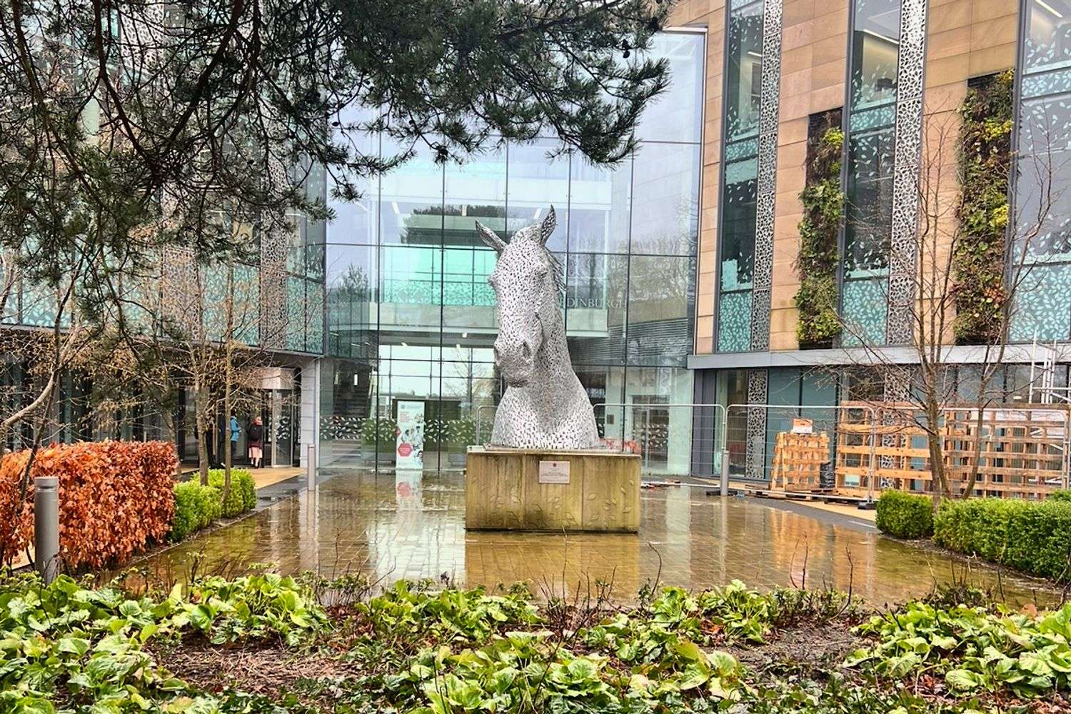 Image of a courtyard with a horse statue in the center. 