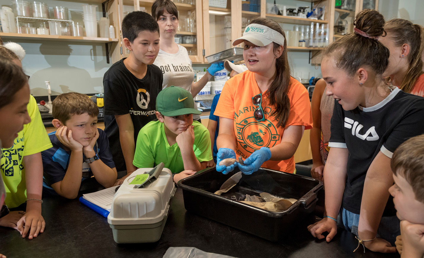 Staff examining shells with youth
